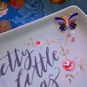 Cloisonne-style butterfly pin in blue, black, and white with gold metal …